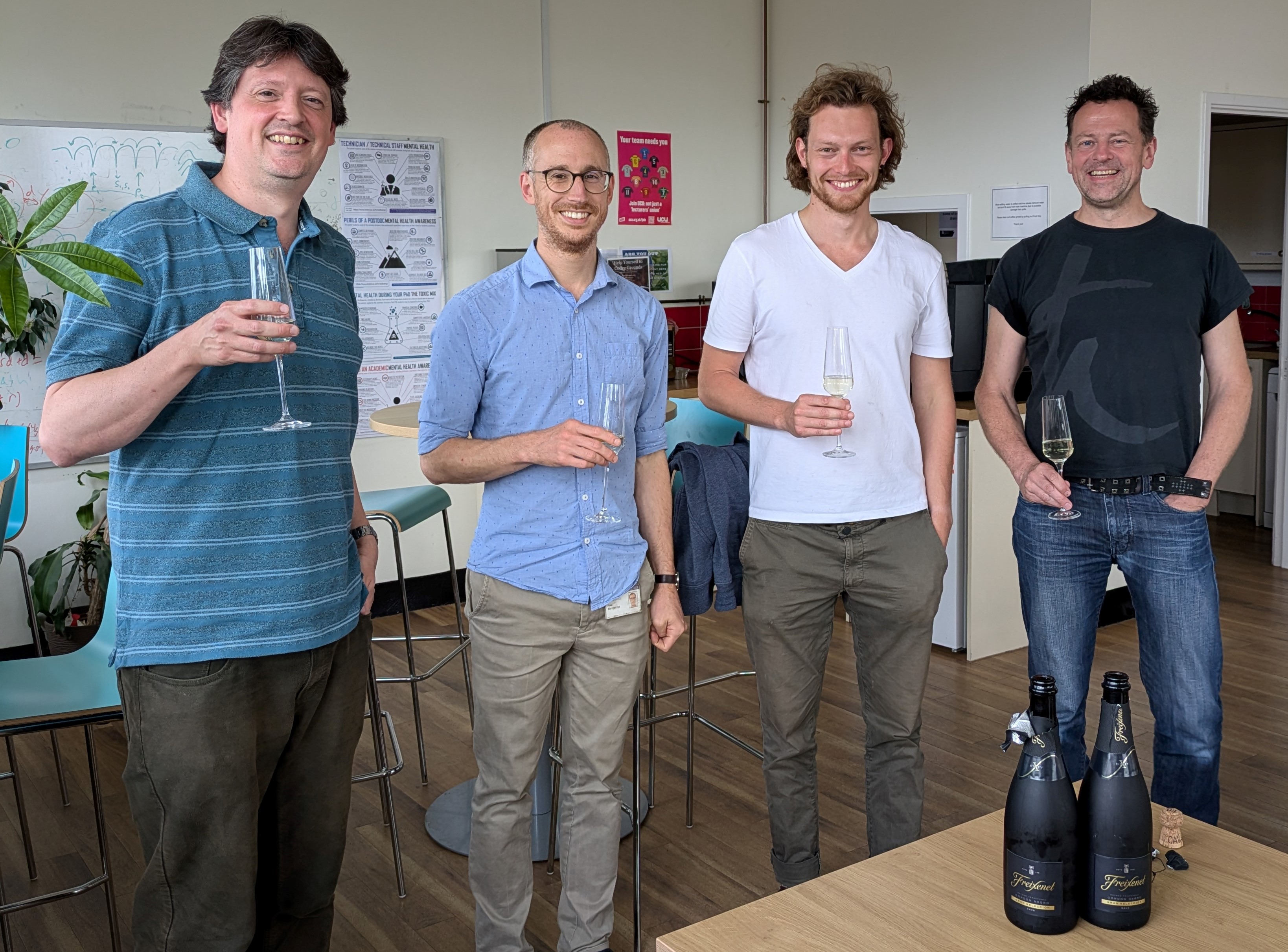 Photo of Tony Short, Paul Skrzypczyk, Ben Jones and Andreas Winter toasting Ben's viva success